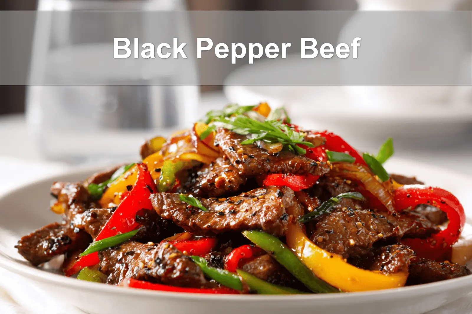 Black Pepper Beef dish with colorful peppers and glass of water