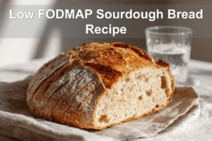 Low FODMAP Sourdough Bread Recipe finished loaf on white napkin and glass of water