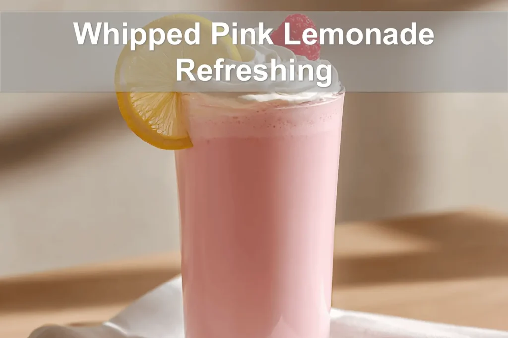 Whipped Pink Lemonade Refreshing Recipe in a clear glass, lightly styled with a raspberry garnish.