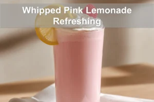 Whipped Pink Lemonade Refreshing Recipe in a clear glass, lightly styled with a raspberry garnish.