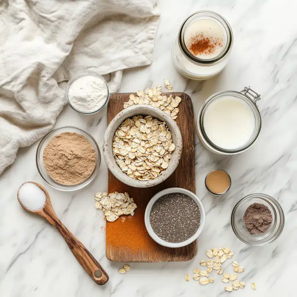 CINNAMON ROLL PROTEIN OVERNIGHT OATS jar with cinnamon swirl on white napkin beside water