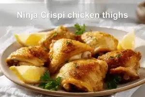 Ninja Crispi chicken thighs crispy golden skin bone-in skin-on chicken pieces on white cloth