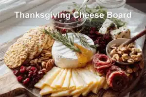 Thanksgiving Cheese Board with brie manchego white cheddar cranberry goat cheese assorted salami