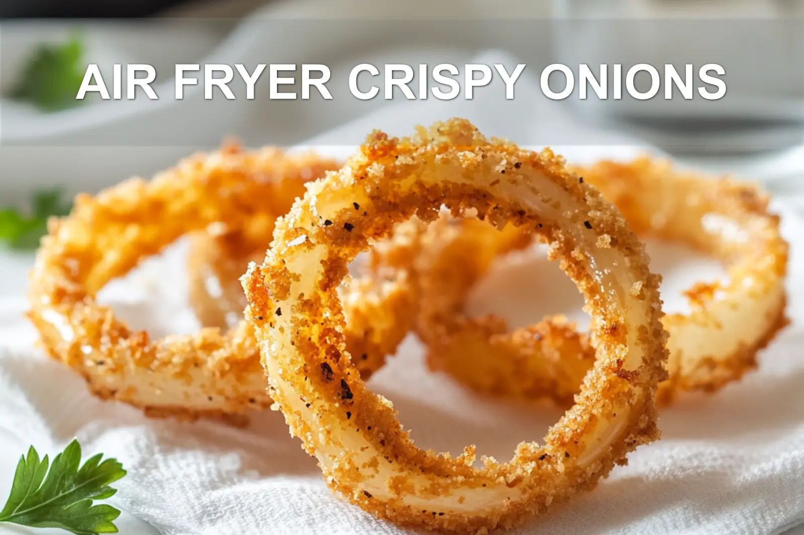 AIR FRYER CRISPY ONIONS golden onion rings on white napkin with clear glass of water