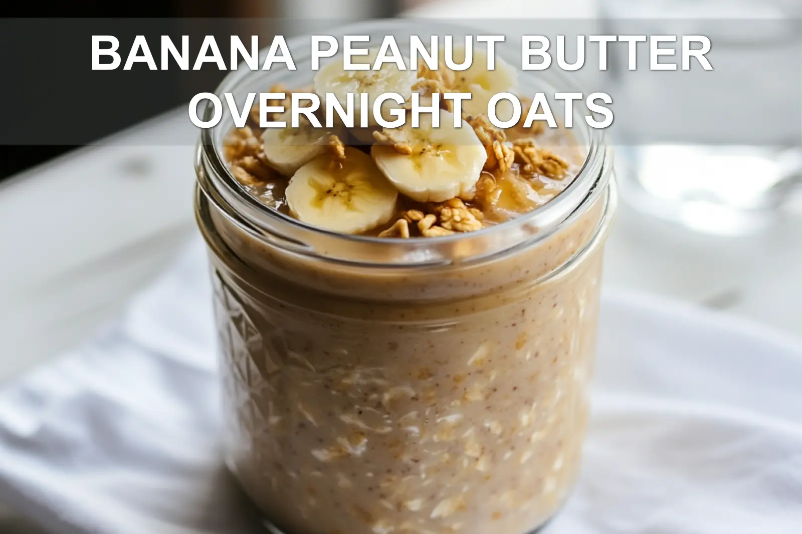 BANANA PEANUT BUTTER OVERNIGHT OATS jar with banana and peanut butter warm natural light