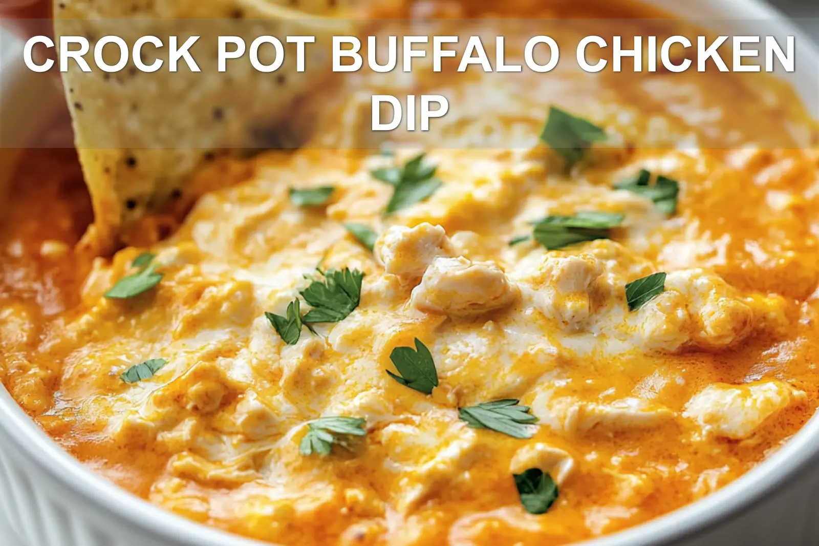 Bubbly Crock Pot buffalo chicken dip with tortilla chips and celery sticks