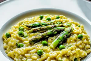SPRING RISOTTO WITH ASPARAGUS AND PEAS centered hero view, clean and uncluttered